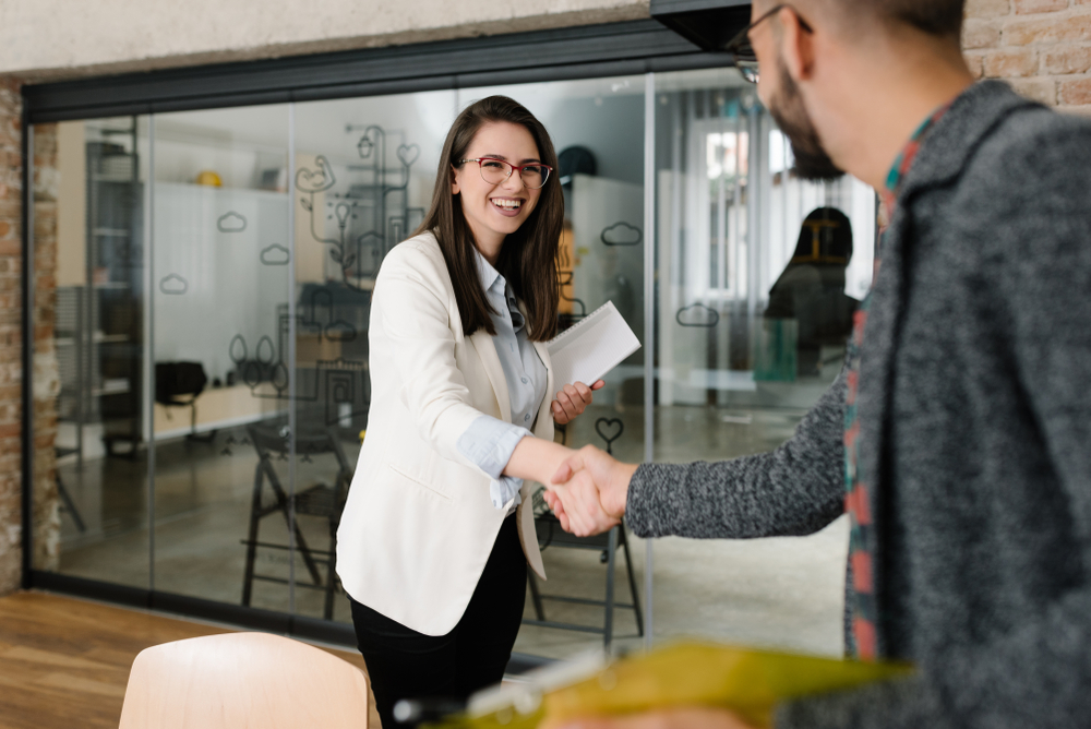 Openly greeting a job recruiter with a firm handshake.