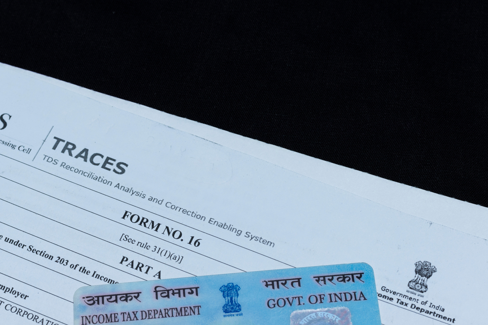 PAN card and form 16 on black background